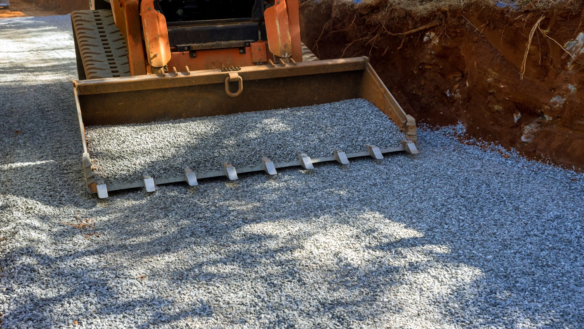 bobcat picking up gravel off the ground