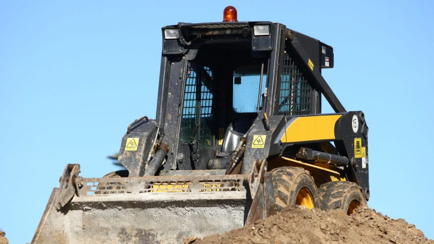 bobcat being driven on top of the hill